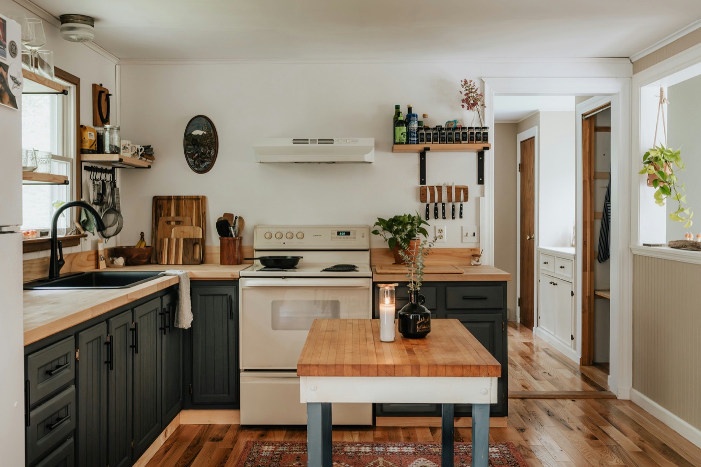 Renovated cottage kitchen with timber benchtops and dark cabinetry